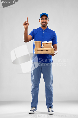 Image of happy indian delivery man with food and drinks