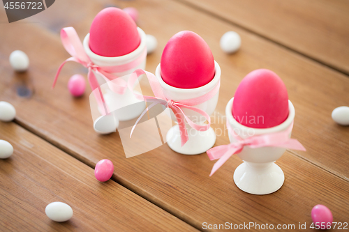 Image of easter eggs in holders and candy drops on table