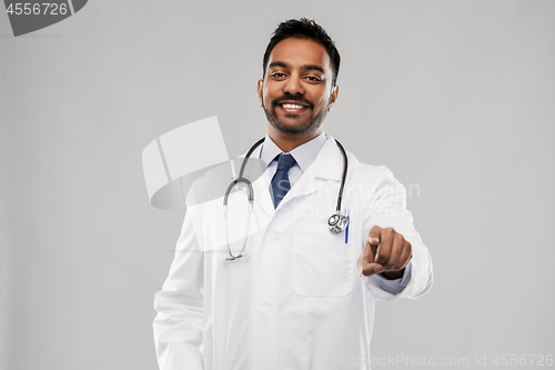 Image of smiling indian male doctor pointing finger to you