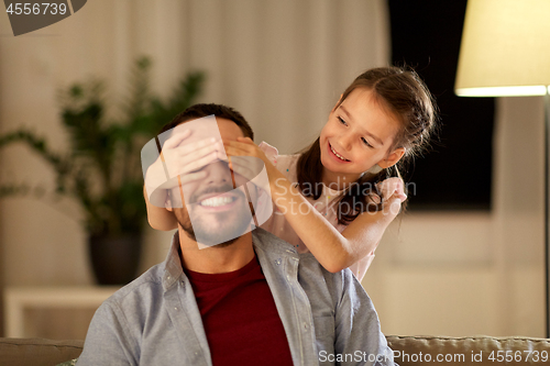 Image of happy father and little daughter playing at home
