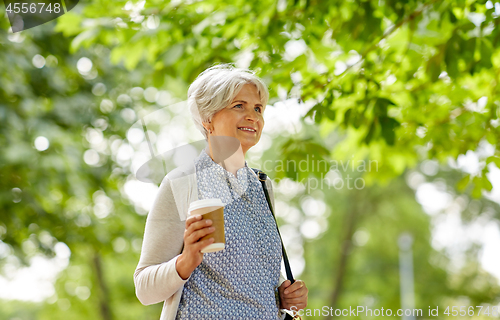 Image of senior woman drinking takeaway coffee at park