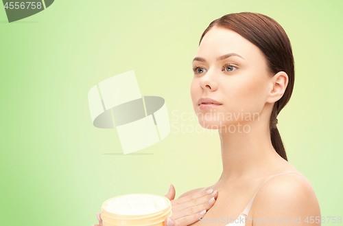 Image of beautiful woman with moisturizing cream