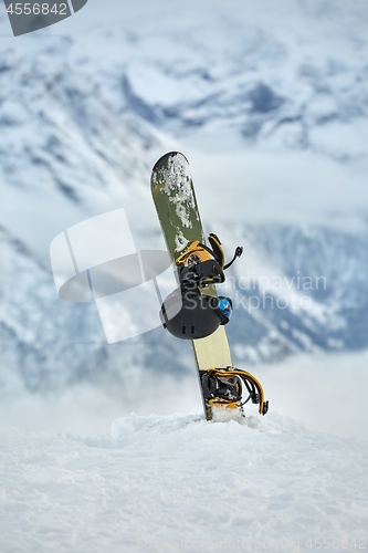 Image of Snowboard high up in the snowy Alps