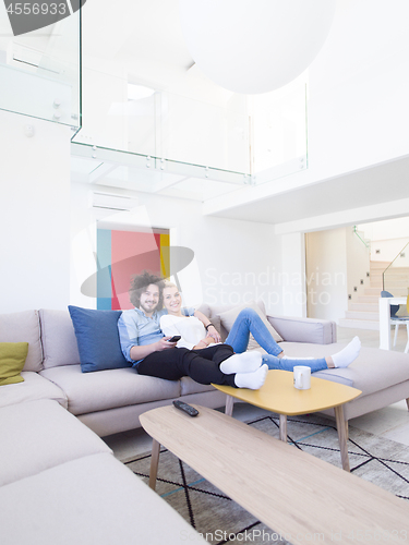 Image of Young couple on the sofa watching television