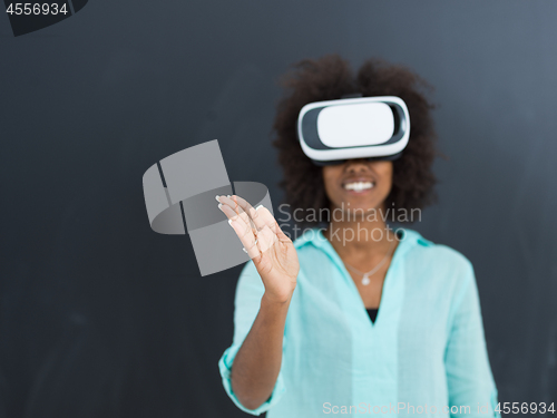Image of black girl using VR headset isolated on gray background