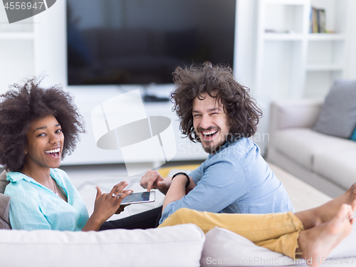 Image of multiethnic couple in living room