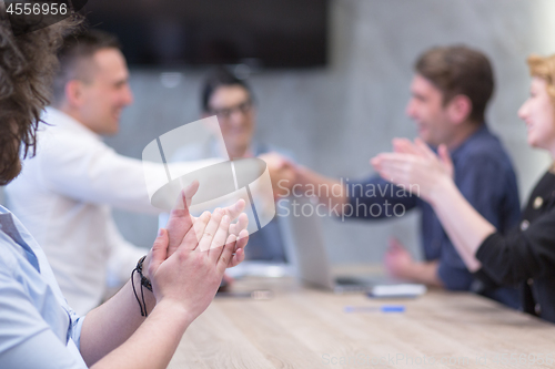 Image of cloasing the deal in modern office interior