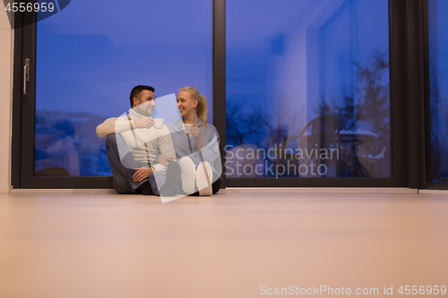 Image of happy couple in front of fireplace