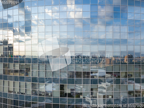 Image of Cityscape reflection on a glass facade of modern office building in Kiev