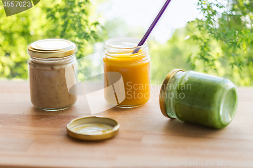 Image of vegetable or fruit puree or baby food in jars