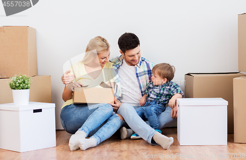 Image of happy family with boxes moving to new home