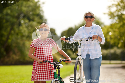 Image of grandmother and granddaughter with bicycles