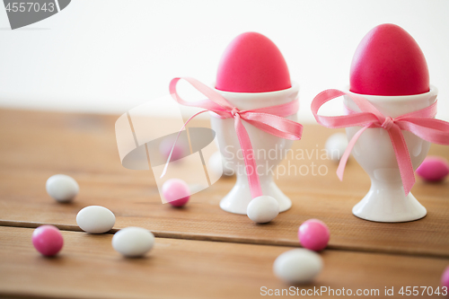 Image of easter eggs in holders and candy drops on table