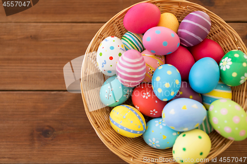 Image of close up of colored easter eggs in basket