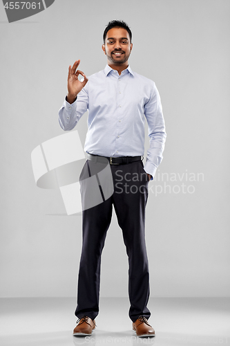 Image of happy indian businessman in shirt over grey