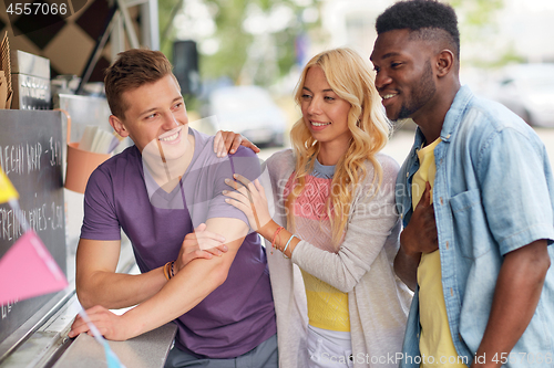 Image of happy customers or friends at food truck