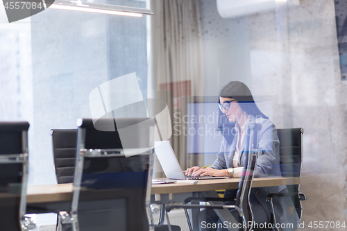 Image of businesswoman using a laptop in startup office