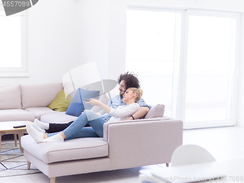 Image of Young couple on the sofa watching television