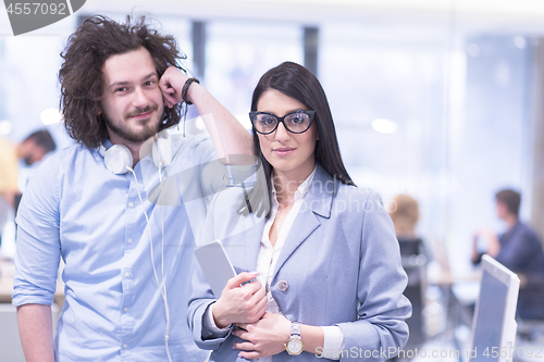 Image of Business People Working With Tablet in startup office