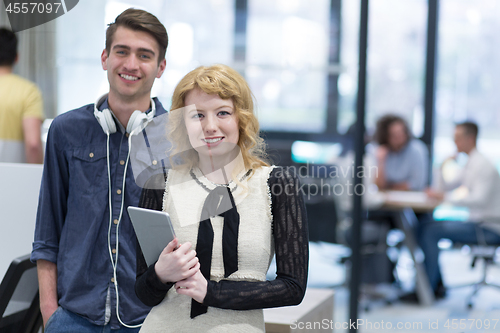 Image of Business People Working With Tablet in startup office