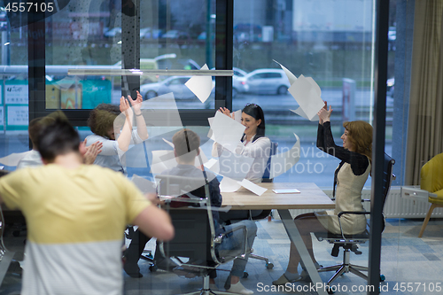 Image of startup Group of young business people throwing documents