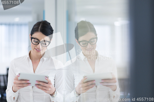 Image of Business Woman Using Digital Tablet in front of startup Office