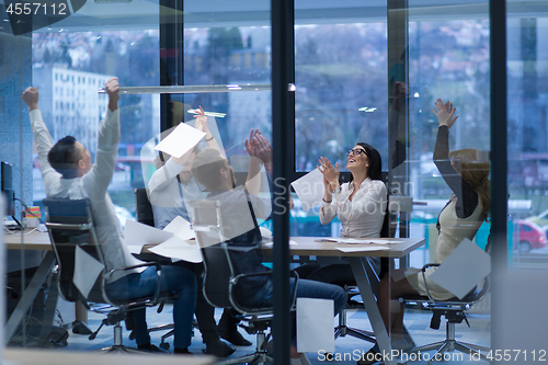 Image of startup Group of young business people throwing documents