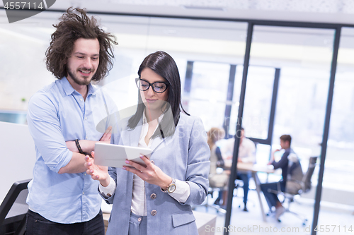 Image of Business People Working With Tablet in startup office