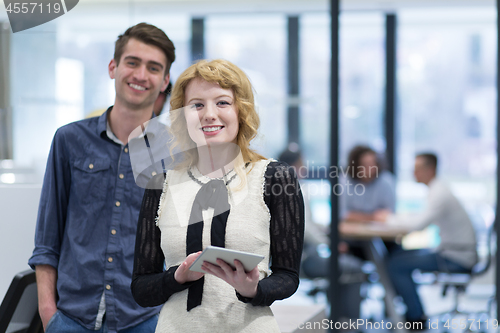 Image of Business People Working With Tablet in startup office