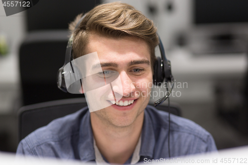 Image of male call centre operator doing his job