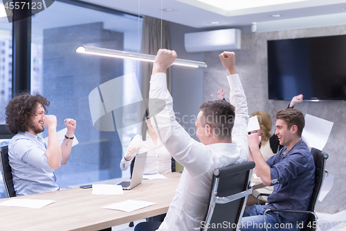 Image of startup Group of young business people throwing documents