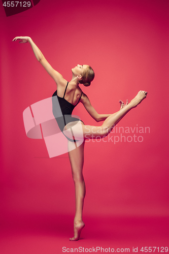 Image of Young teen dancer on red studio background.