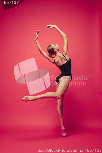 Image of Young teen dancer on red studio background.