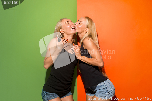 Image of Portrait of attractive cute girls with bright makeup with kiss