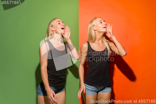 Image of The young casual women shouting at studio