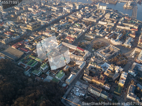 Image of The panoramic bird\'s eye view from drone to the central historical part of the city Kiev - the Podol district, the Dnieper River in Kiev, Ukraine at summer sunset.