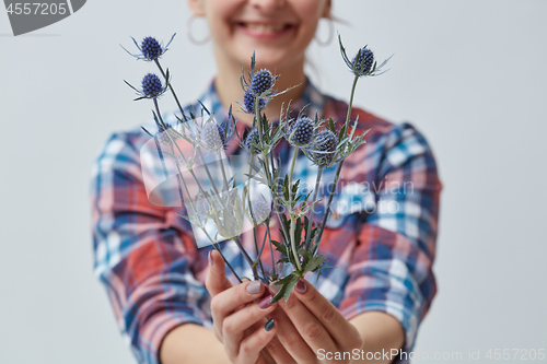 Image of Young girl holding a blue flower
