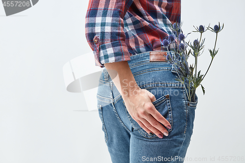 Image of Woman with blue flowers eryngium