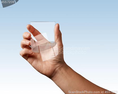 Image of transparent glass represented in hand
