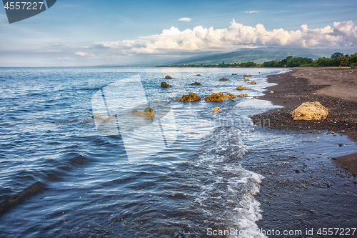 Image of a dark sand beach in northern Bali Indonesia