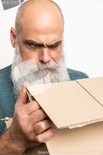 Image of skeptical looking bearded man with a carton box
