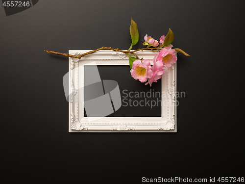 Image of white frame on black background with cherry blossoms