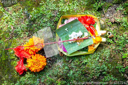 Image of Votive offering with flowers, cookies and ribbons