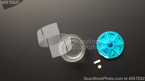 Image of open pillbox with some pills