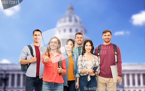 Image of students showing thumbs up over capitol building