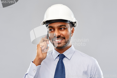 Image of indian architect in helmet calling on smartphone