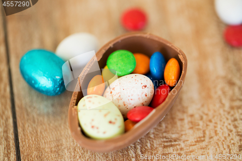 Image of chocolate easter egg and candy drops on table