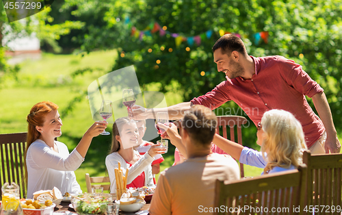 Image of happy family having dinner or summer garden party