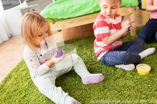 Image of children with modelling clay or slimes at home