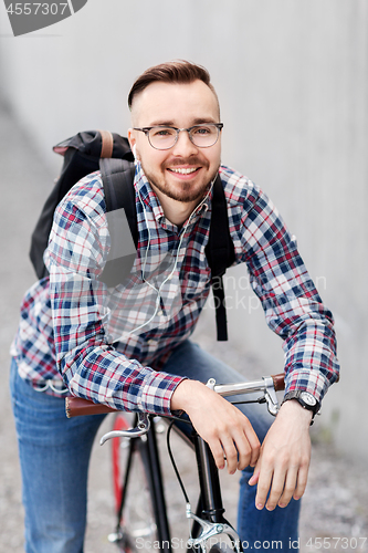 Image of hipster man with fixed gear bike and backpack